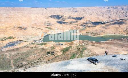 DHIBAN, JORDAN - FEBRUARY 20, 2012: people at viewpoint over Al Mujib dam on Wadi Mujib river on King's highway in winter. King's Road was trade route Stock Photo