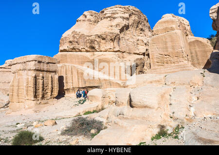 PETRA, JORDAN - FEBRUARY 21, 2012: tourists near Djinn Blocks at Bab as-Siq road to Petra town in winter. Rock-cut town Petra was established about 31 Stock Photo