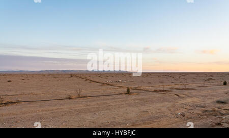 Travel to Middle East country Kingdom of Jordan - flat land along Desert Highway (Road 15) in Jordan in winter evening Stock Photo