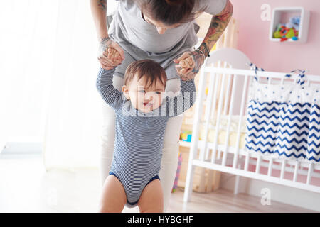 First walk with mummys help Stock Photo