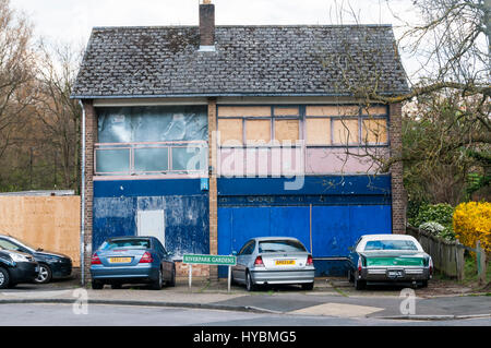 A semi-derleict and boarded up closed shop. Stock Photo