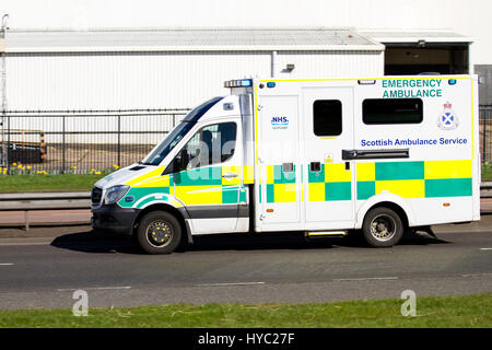 A NHS Scottish Ambulance Service ambulance speeding along the Kingsway West Dual Carriageway responding to a 999 emergency call in Dundee, Scotland Stock Photo