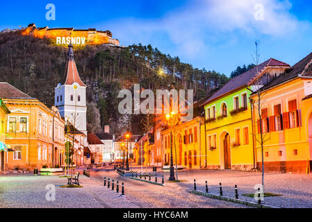 Rasnov, Romania. Evening twilight with medieval saxon city in Transylvania and hilltop ruins of the fortress. Stock Photo