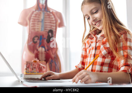Charismatic gifted student working on her assignment Stock Photo