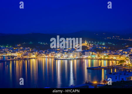 Aerial panoramic view of Tinos town. Centered the famous church of Virgin Mary illuminated at night. Tinos island Cyclades, Greece. Stock Photo