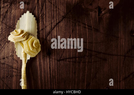 closeup of a small traditional spanish braided palm to be blessed on Palm Sunday on a rustic wooden surface with a blank space Stock Photo