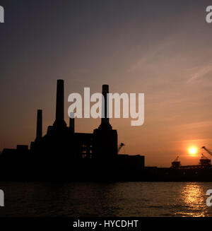 Sunset over Battersea Power Station in 1984 Battersea Power Station is a decommissioned coal-fired power station located on the south bank of the River Thames, in Nine Elms, Battersea, an inner-city district of South West London. It comprises two individual power stations, built in two stages in the form of a single building. Battersea A Power Station was built in the 1930s, with Battersea B Power Station to the east in the 1950s. The two stations were built to a nearly identical design, providing the long-recognized four-chimney layout. The station ceased generating electricity in 1983, but o Stock Photo