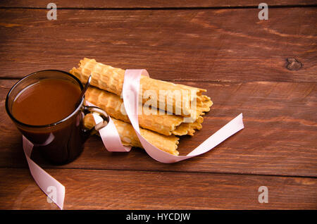 tubular wafer. hot chocolate. waffles on wooden boards Stock Photo