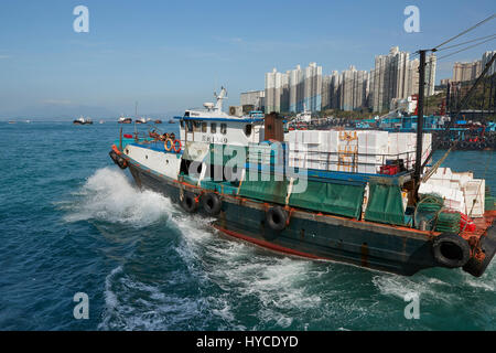 Commercial Fishing Boat Leaves Aberdeen Harbour, Hong Kong. Stock Photo