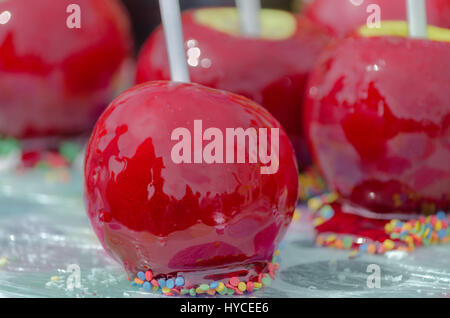 Fresh apples covered with caramel, lie on a market stall Stock Photo