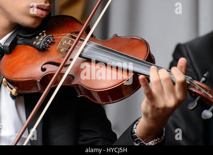 Violinist Playing a Note During a Symphony Stock Photo