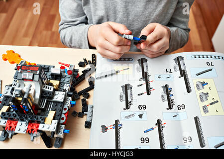 Boy collects the children's plastic construction toys Stock Photo