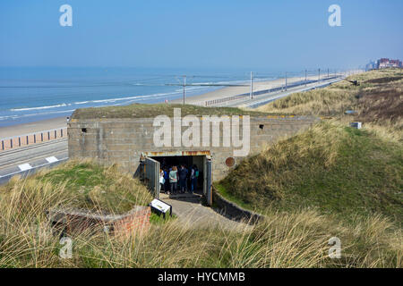 Tourists visiting German WWII bunker in the dunes of the Raversyde Atlantikwall / Atlantic Wall open-air museum at Raversijde, West Flanders, Belgium Stock Photo