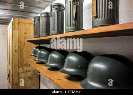 German WWII M1942 Stahlhelms / helmets and gas mask canisters at the Raversyde Atlantikwall / Atlantic Wall open-air museum at Raversijde, West Flande Stock Photo