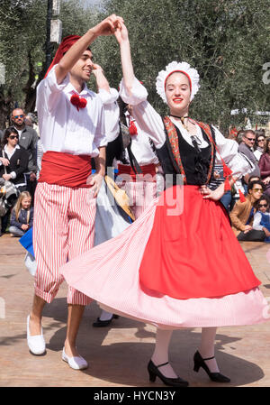 Folk dancers of Nice, France performing a traditional dance of the Alpes-Maritime region in authentic costumes of the area. Stock Photo