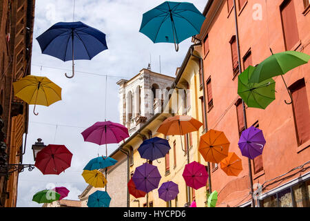 Celebration of the Saint's day of Ferrara, Saint George, with a display of open umbrellas lining a major pedestrian street in the old part of the city. Stock Photo