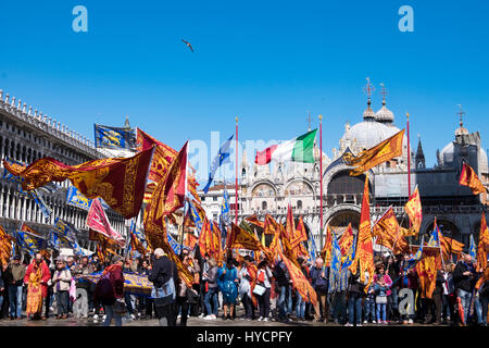 Revelers celebrate the Festa di San Marco, the feast day of Venice's patron saint in the Piazza San Marco Stock Photo