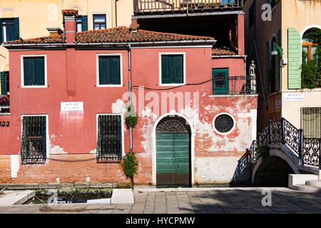 Typical house in Venetian style and colors along a canal in Venice, Italy Stock Photo