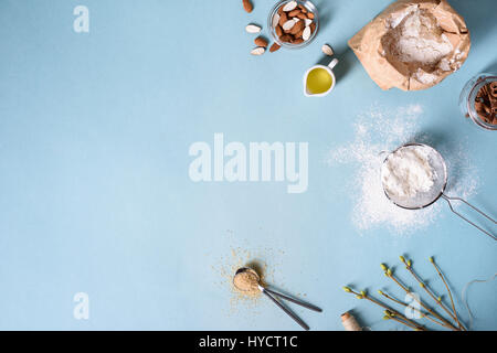 Baking ingredients for pastry on the blue background. Cooking cakes or bread concept. Top view, copy space. Stock Photo