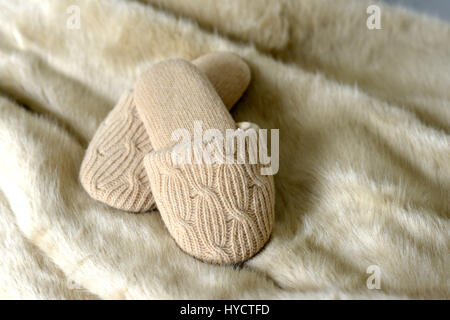 Knitted slippers on faux fur rugs Stock Photo