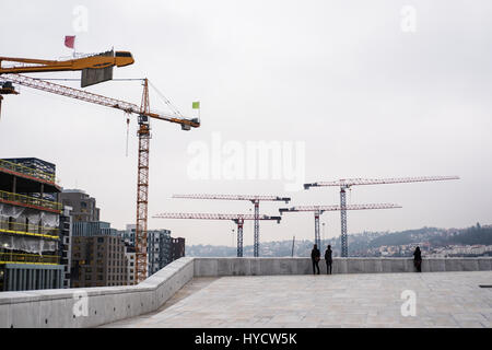 Developing city, site construction with cranes and, contractors Stock Photo