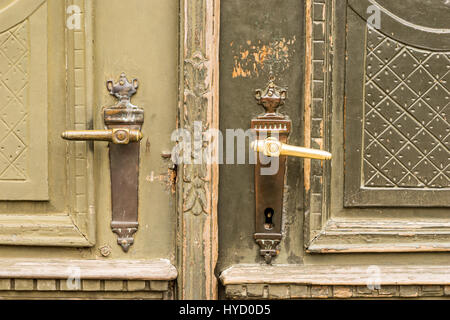 Brass door handles on elegant vintage green painted front door Stock Photo