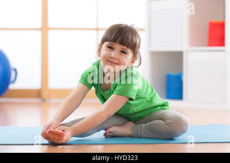 Little girl doing fitness exercises Stock Photo