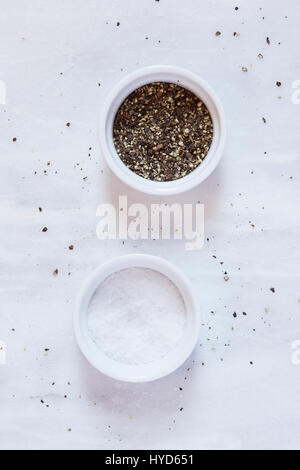 On the kitchen counter there is salt, pepper, cinnamon and olive