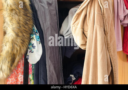 Pile of carelessly scattered clothes in wardrobe Stock Photo