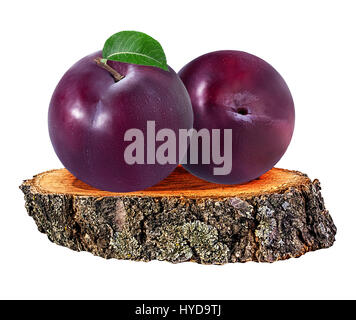plum  on a wooden сross section of tree trunk isolated on white background Stock Photo