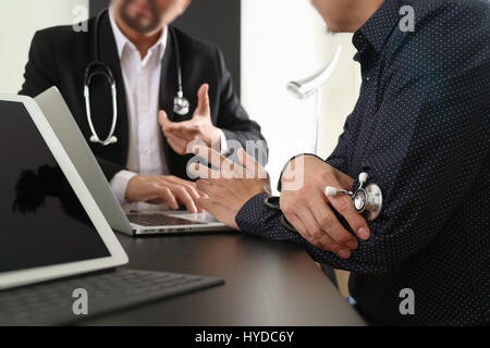Medical co working concept,Doctor working with digital tablet and laptop computer formeeting his team in modern office at hospital Stock Photo