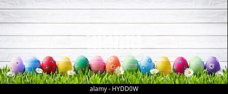 Easter Eggs In A Row And White Wooden Background Stock Photo