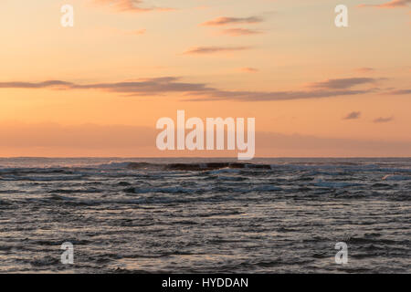 The morning sky over ocean waves at Durras Beach, Australia Stock Photo
