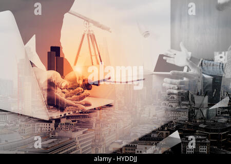 co working team meeting concept,businessman using smart phone and digital tablet and laptop computer in modern office with London city exposure Stock Photo
