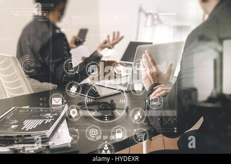 co working meeting,two businessman using VOIP headset with latop computer on desk in modern office as call center and customer service help desk conce Stock Photo