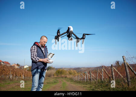 Man from ground remote control drone's flight Stock Photo