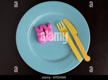 Two pink Peeps bunnies on a plate. Stock Photo