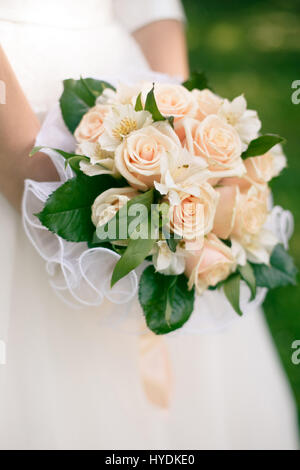 Wedding bouquet from peach-colored roses and alstroemeria Stock Photo