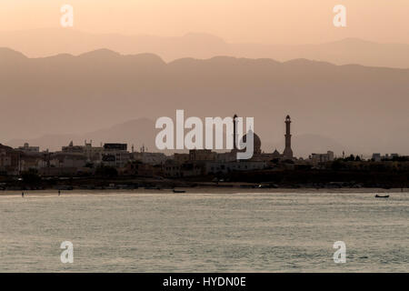 coastal city of Sur with mosque at sunset, south Oman Stock Photo