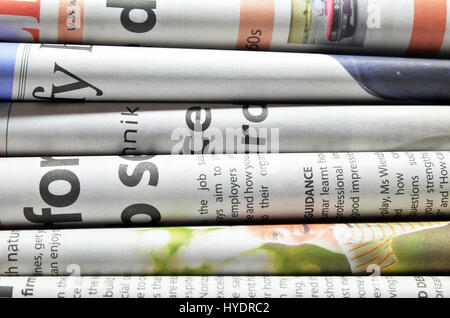 Newspapers folded and stacked isolated on white Stock Photo