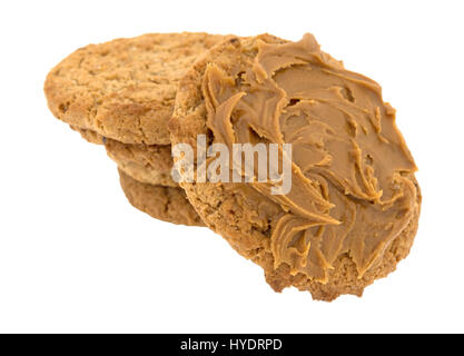 A single oatmeal cookie with cookie butter plus several cookies in a stack isolated on a white background. Stock Photo