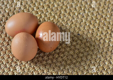 Chicken eggs on a mat Stock Photo