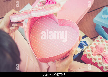 Girl open heart shaped gift box with copy space. Vintage or Retro tone. top view. Stock Photo