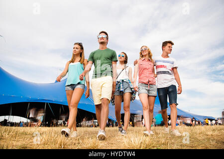 Teenagers at summer music festival in front of big blue tent Stock Photo