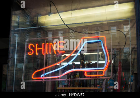 Neon sign in window of shoe shine parlor Stock Photo