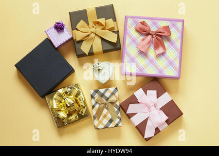A lot of gift boxes with bows on a beige background Stock Photo