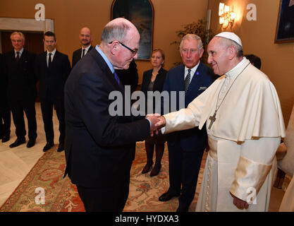 The Sun royal photographer Arthur Edwards shakes hands with Pope Francis at the Vatican during a visit by The Prince of Wales (centre). Stock Photo