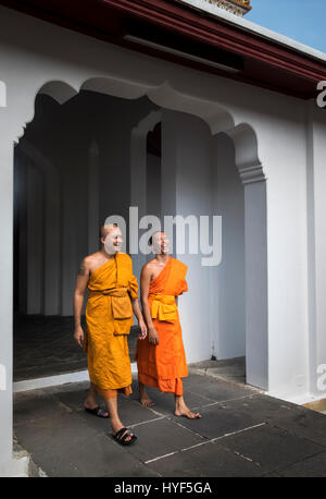 BANGKOK, THAILAND - CIRCA SEPTEMBER 2014: Buddhist monks walking relaxed inside Wat Arun, a  popular Buddhist temple in Bangkok Yai district of Bangko Stock Photo