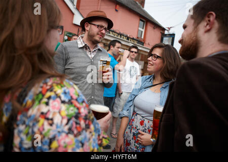 People stood outside socializing and drinking, The Literary Festival, Laugharne, Wales, Uk Stock Photo