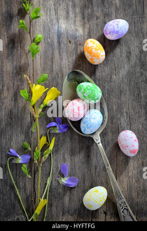 Easter wooden table setting with eggs and flowers Stock Photo